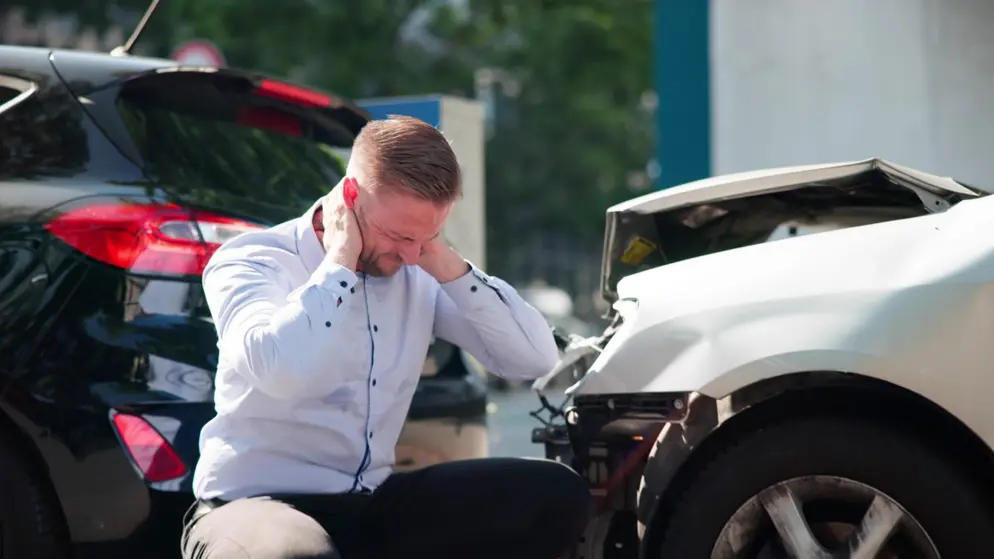 Person assessing the scene after an accident that wasn't their fault in the UK